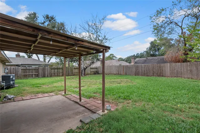 a view of a backyard with wooden fence