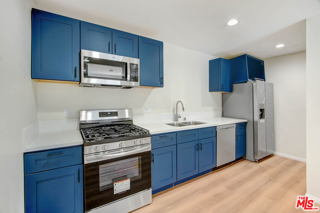 613 Pico Street San Fernando, CA 91340 - Photo 3 of 10 a kitchen with stainless steel appliances a stove a sink dishwasher a refrigerator and a microwave