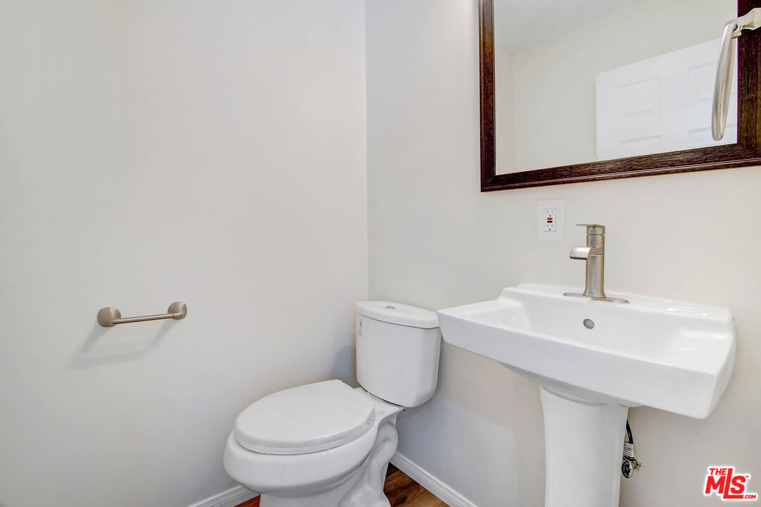 613 Pico Street San Fernando, CA 91340 - Photo 10 of 10 a bathroom with a sink a toilet and mirror