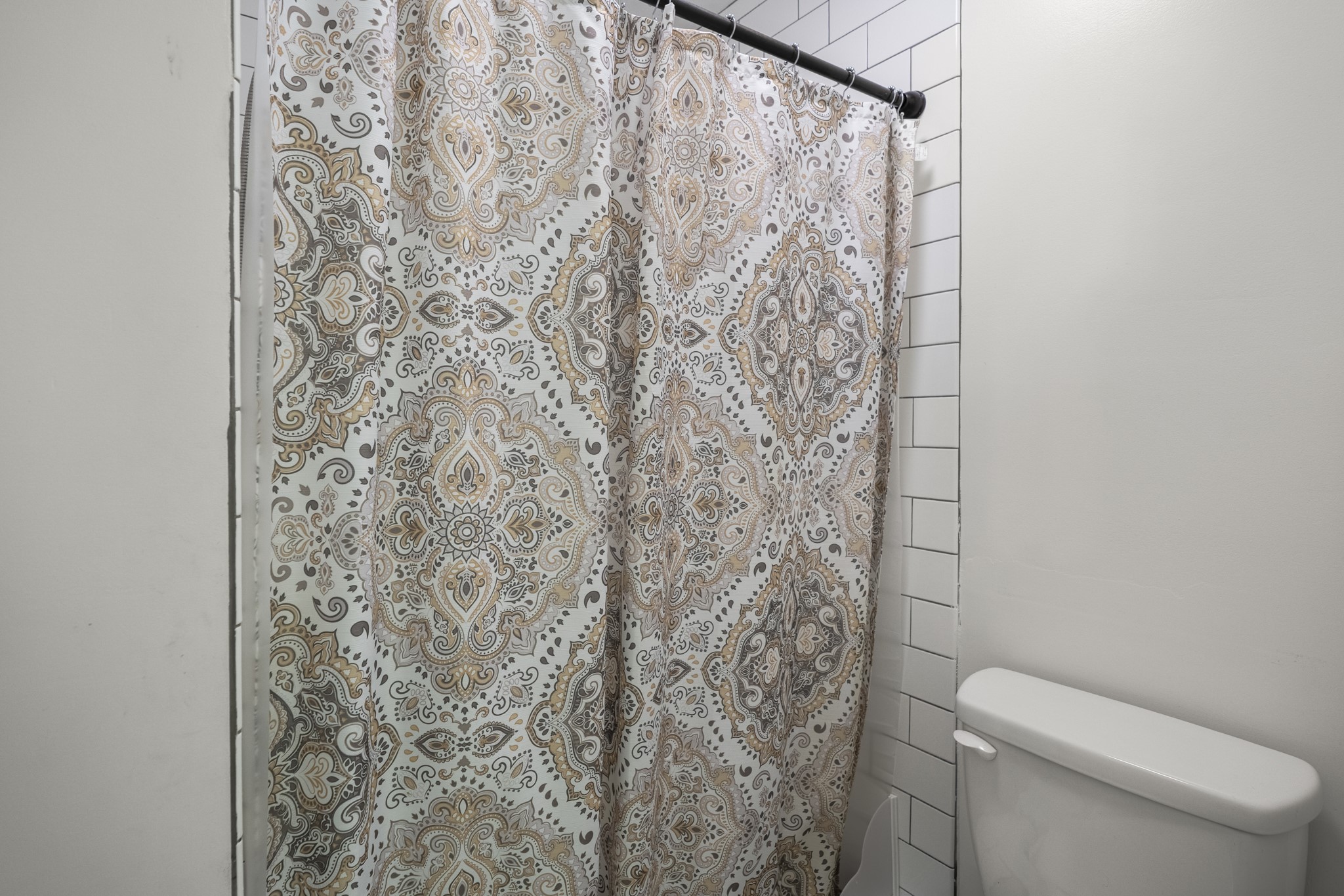 12224 Gun Oak Place Spring, TX 77380 - Photo 26 of 43 The stand up shower in primary bathroom features classic white subway tile paired with warm, inviting finishes that bring both character and comfort to the space.