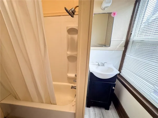 a bathroom with a sink a mirror and shower