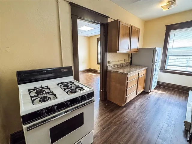 a kitchen with stainless steel appliances granite countertop a stove and a refrigerator