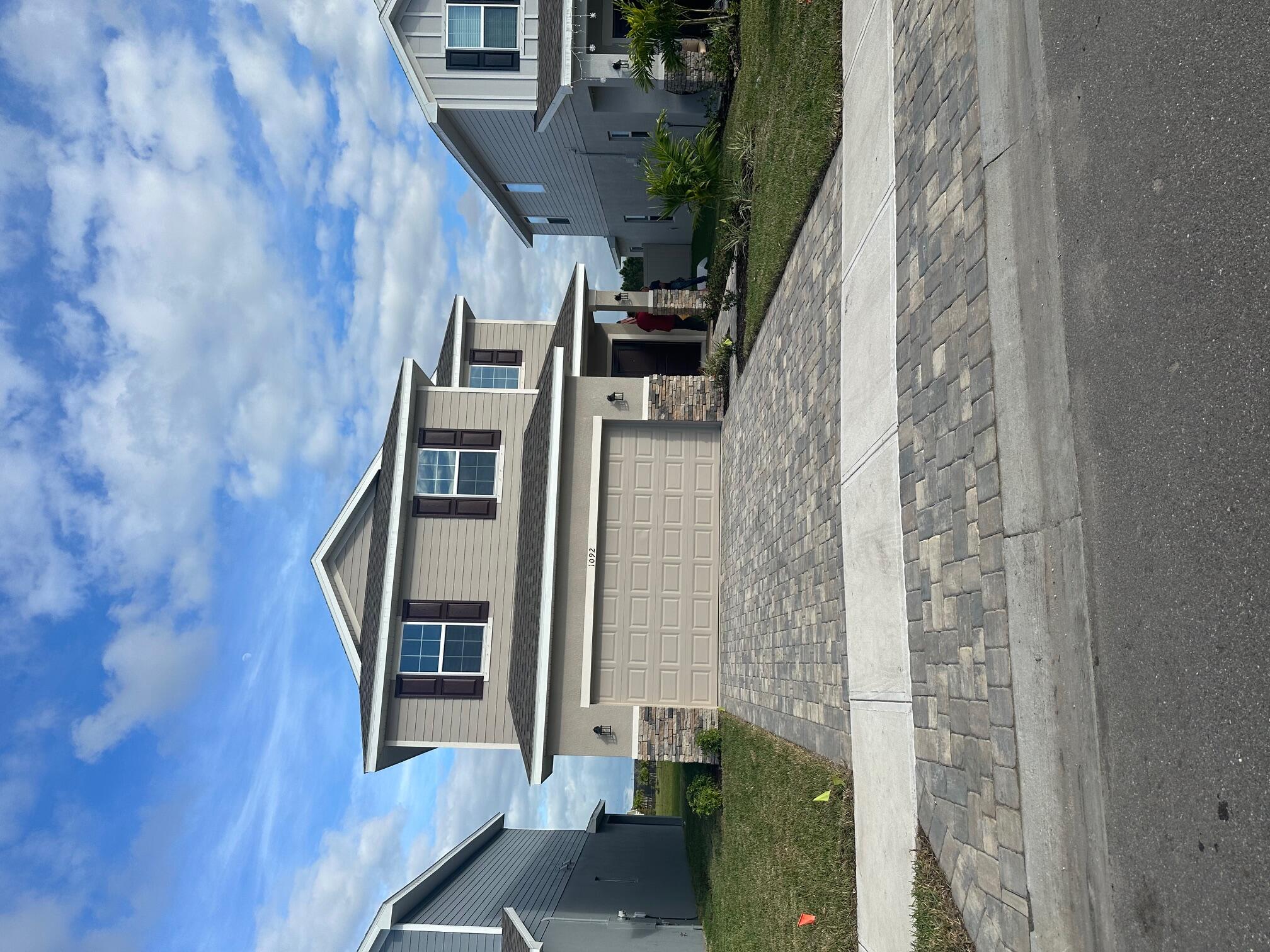 1092 Canfield Circle Palm Bay, FL 32909 - Photo 1 of 24 a front view of a house with a yard