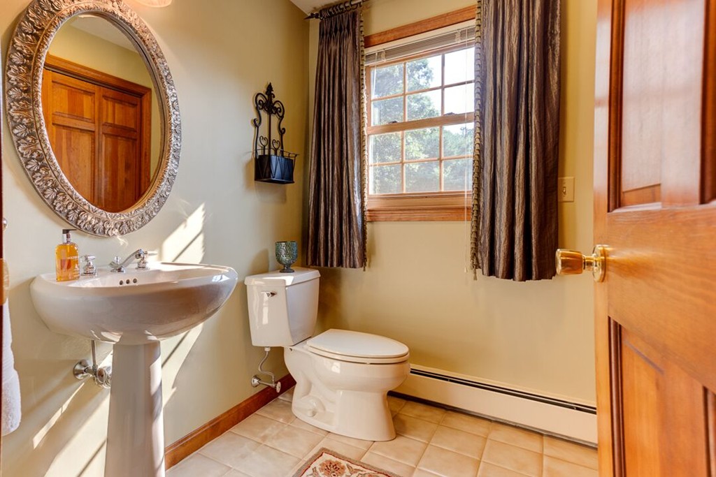 20 Indigo Farm Road North Smithfield, RI 02830 - Photo 19 of 30 a bathroom with a sink a mirror a toilet and a window