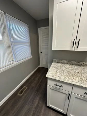 a bathroom with a granite countertop sink and dishwasher