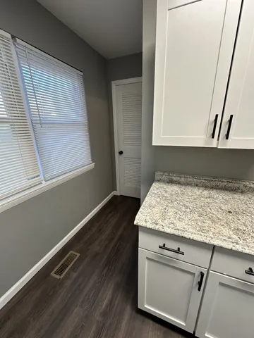 a bathroom with a granite countertop sink and dishwasher