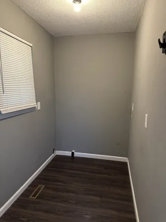 a view of a room with wooden floor and window