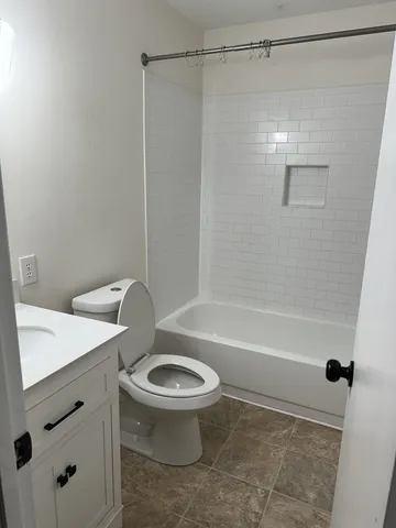 a bathroom with a sink a toilet and a bathtub