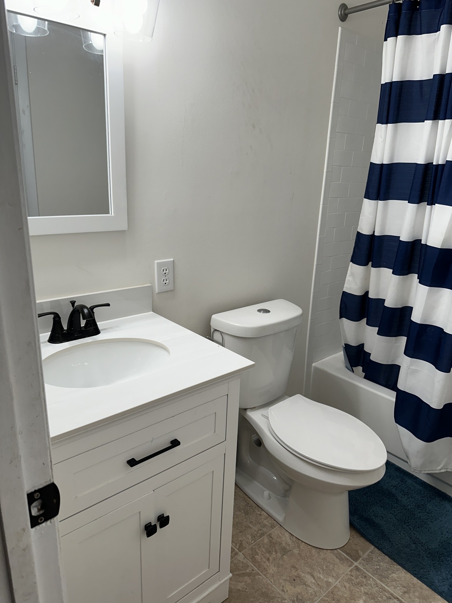 69 Hasty Hollow Road Lynchburg, TN 37352 - Photo 2 of 21 a bathroom with a sink a toilet a mirror and shower