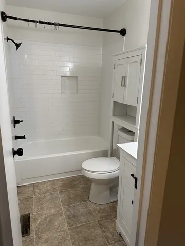a bathroom with a toilet and a shower