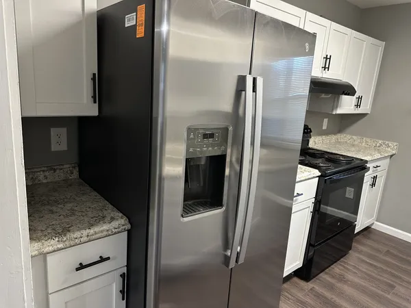 a kitchen with a refrigerator and a sink