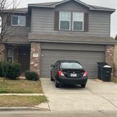 a view of a car parked front of a house