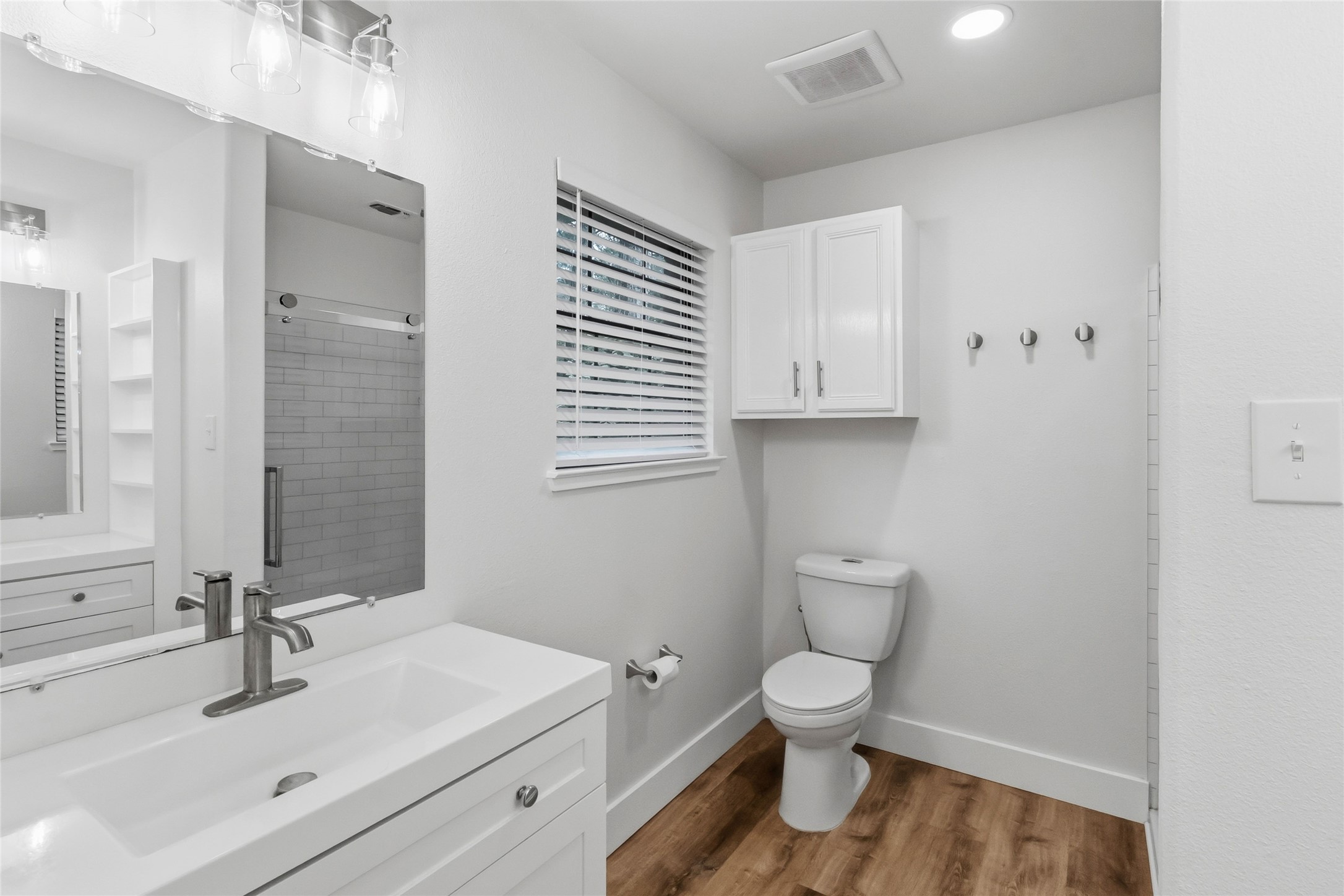 326 Pine View Loop Bastrop, TX 78602 - Photo 20 of 30 A well-appointed bathroom features a sleek vanity, modern fixtures, and durable wood-look flooring.
