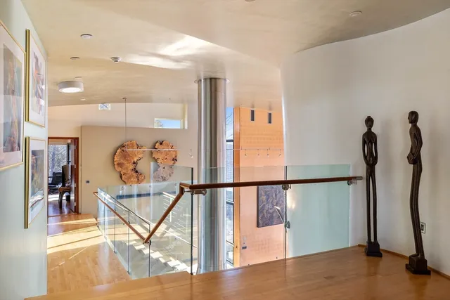 a view of a hallway with wooden floor and a chandelier