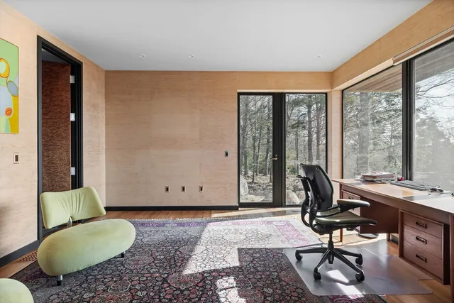 a living room with furniture and large windows