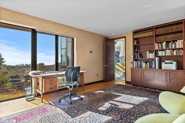 a living room with furniture a rug and a large window