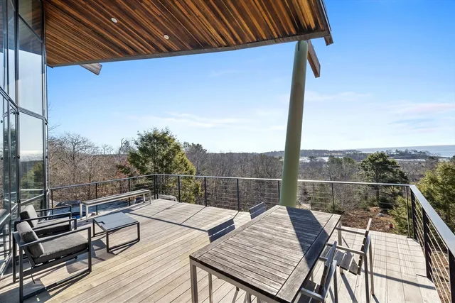a view of a roof deck with couches and wooden floor
