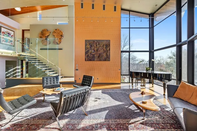a living room with furniture and a floor to ceiling window