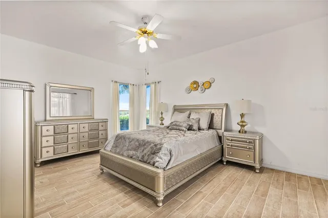a bedroom with a bed and a chandelier