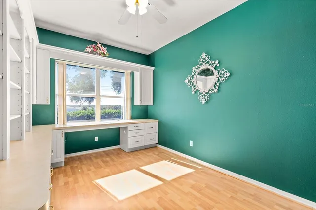 a bed room with a window and a chandelier