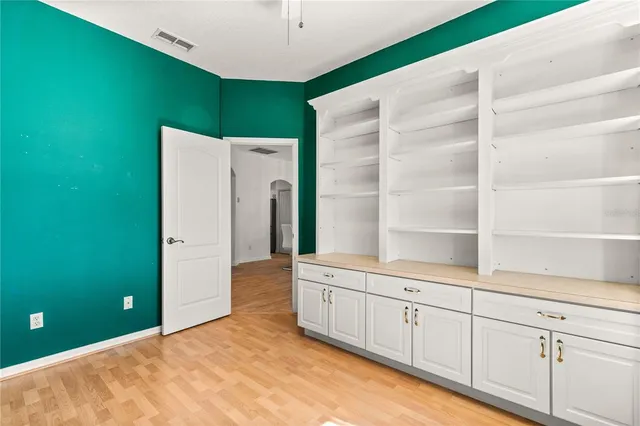 a kitchen with cabinets and a refrigerator