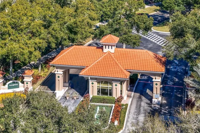 an aerial view of residential houses with outdoor space and lake view