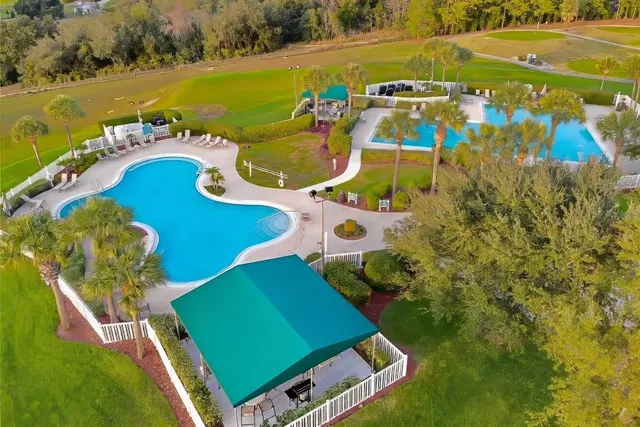 a view of a swimming pool with a yard