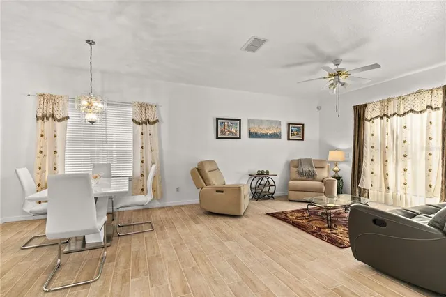 a living room with furniture and a chandelier