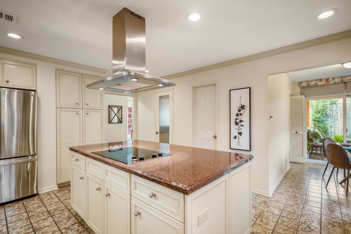 1306 Riverview Court Houston, TX 77077 - Photo 13 of 43 a kitchen with stainless steel appliances granite countertop a refrigerator a sink dishwasher and white cabinets with wooden floor