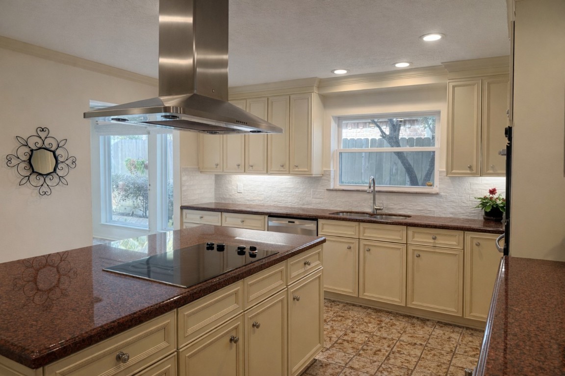 1306 Riverview Court Houston, TX 77077 - Photo 16 of 43 a kitchen with granite countertop a sink stainless steel appliances and cabinets