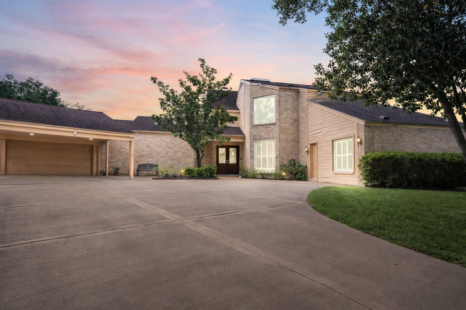 1306 Riverview Court Houston, TX 77077 - Photo 2 of 43 a front view of a house with a yard and garage