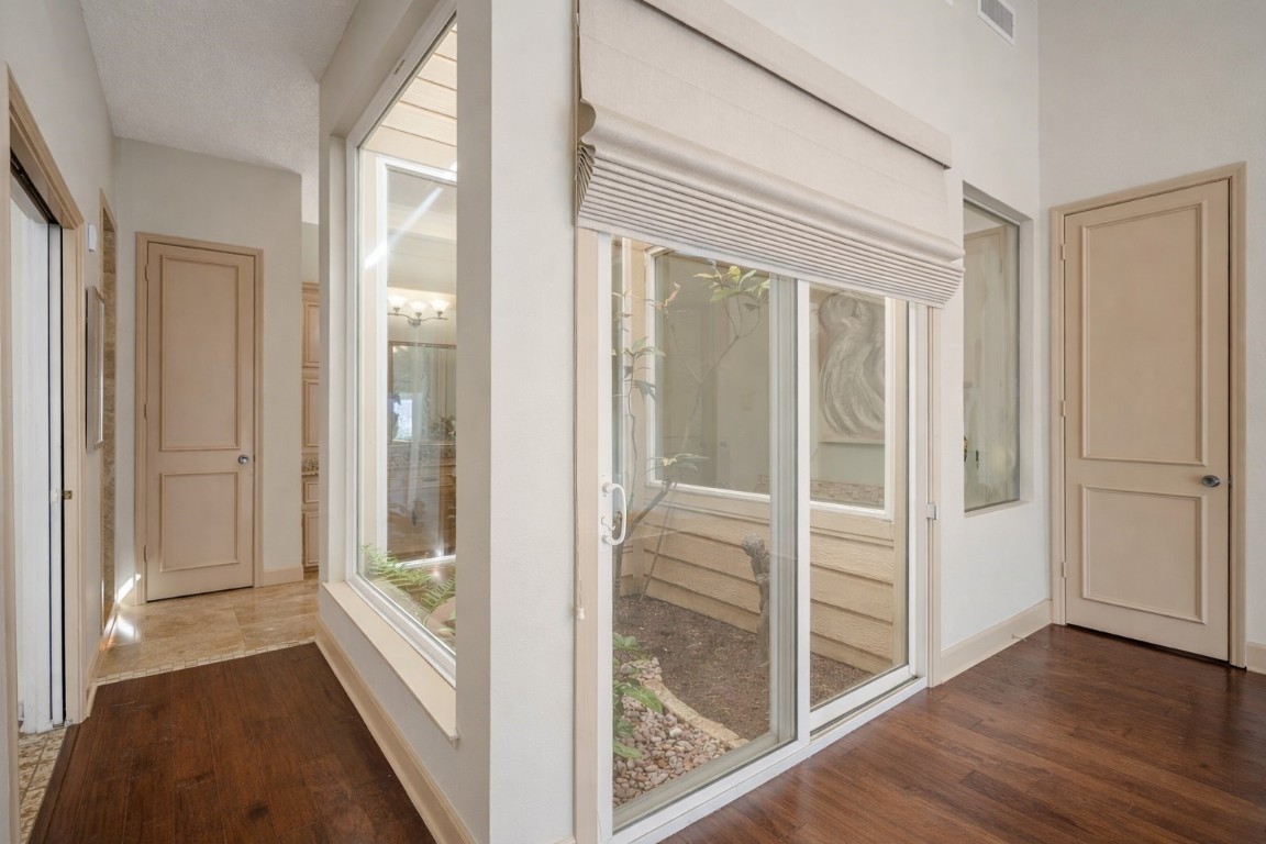 1306 Riverview Court Houston, TX 77077 - Photo 25 of 43 a view of a hallway with wooden floor and glass door
