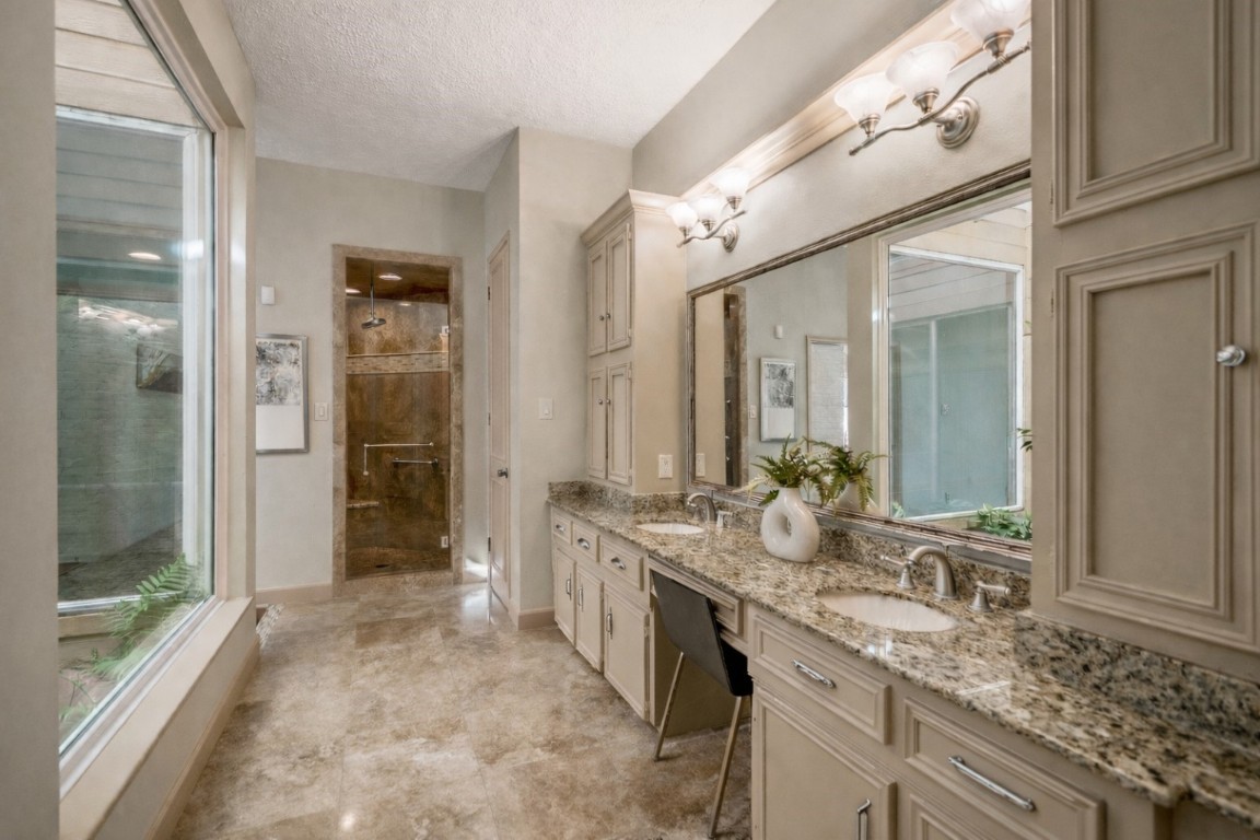 1306 Riverview Court Houston, TX 77077 - Photo 27 of 43 a spacious bathroom with a granite countertop sink mirror and a shower