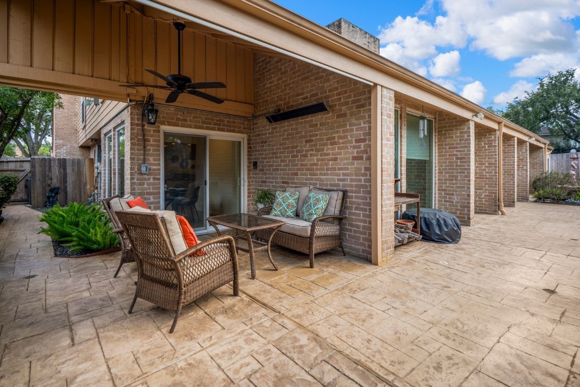 1306 Riverview Court Houston, TX 77077 - Photo 35 of 43 a view of a patio with table and chairs with wooden fence and plants