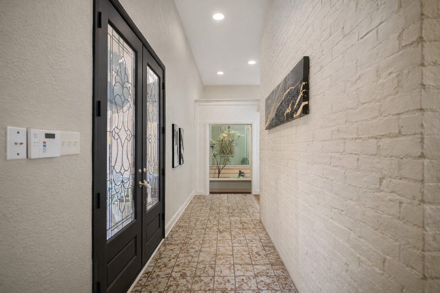 1306 Riverview Court Houston, TX 77077 - Photo 8 of 43 a view of hallway with walk in closet and wooden floor