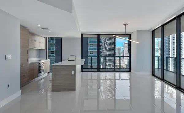 a kitchen with stainless steel appliances kitchen island granite countertop a refrigerator and cabinets