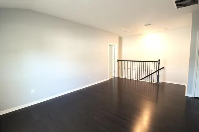 a view of a room with wooden floor