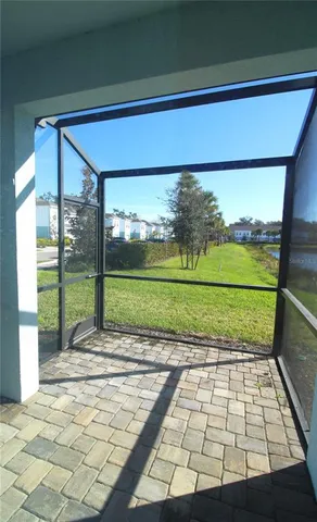 a view of a porch with a floor to ceiling window and a yard