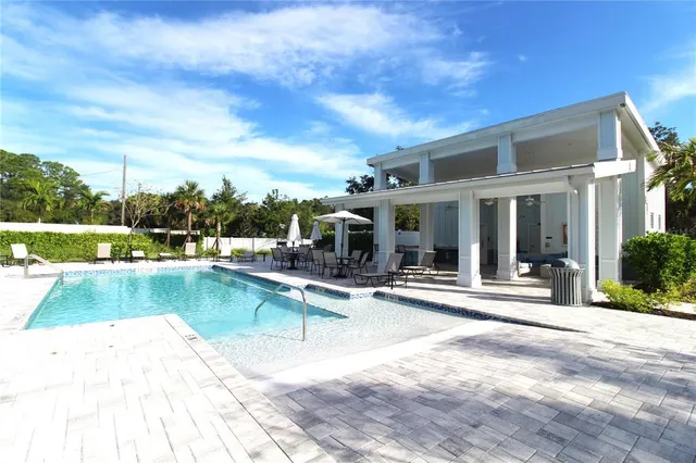 a view of a patio with dining table and chairs with wooden floor and fence
