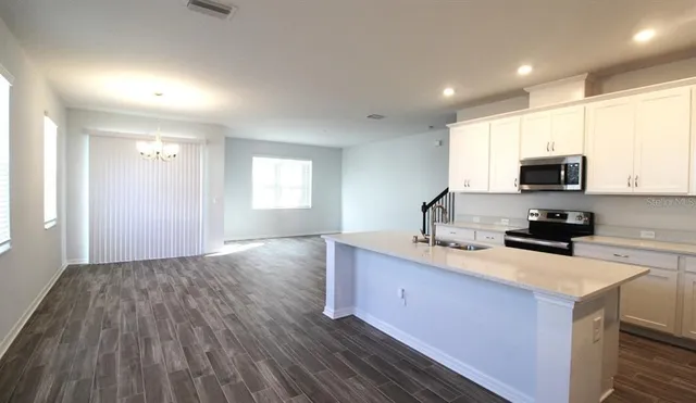 a kitchen with a sink a window and appliances