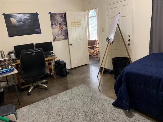a bedroom with a bed and a desk