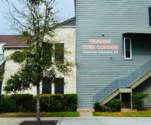 a sign that is on the side of a brick building