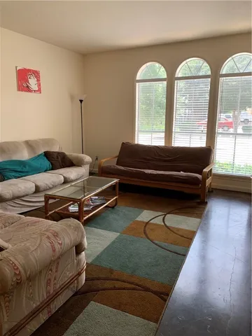 a bedroom with furniture and a large window