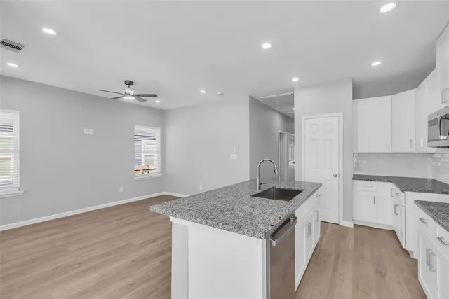 a view of kitchen with refrigerator and window