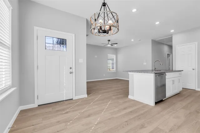 a view of a kitchen with a sink stainless steel appliances and cabinets