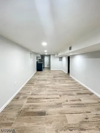 a large room with a bed and a dresser