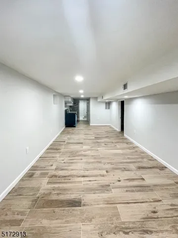 a large room with a bed and a dresser