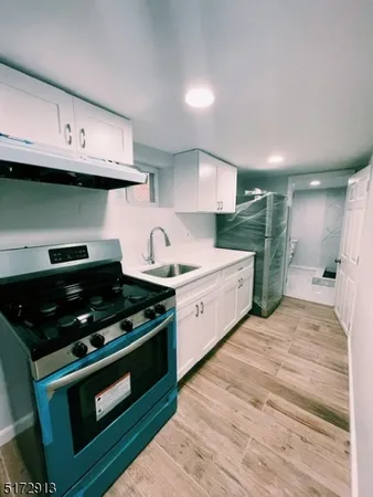 a kitchen with stainless steel appliances granite countertop a stove and a sink
