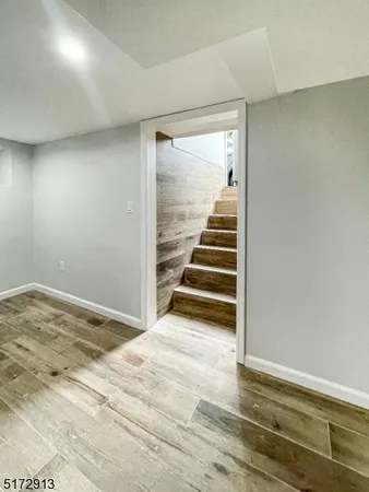 a view of a room with stairs and a wooden floor
