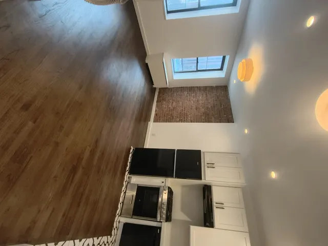 walk in closet with wooden floor